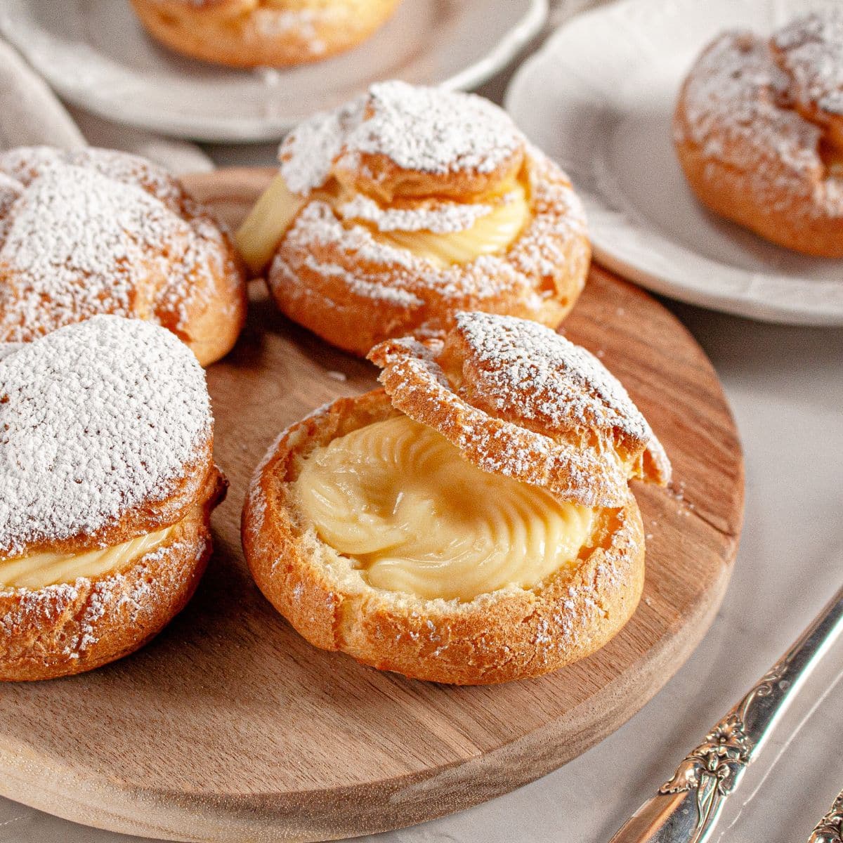 Cream puffs on a wooden lazy susan.