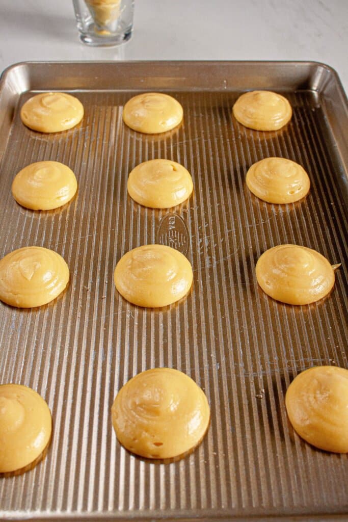 Dough piped onto a baking sheet.