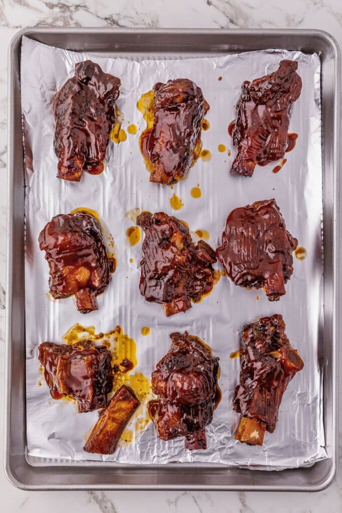 BBQ ribs on a foil-lined baking sheet.