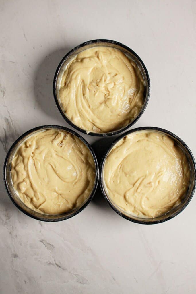 Batter in three round cake pans.
