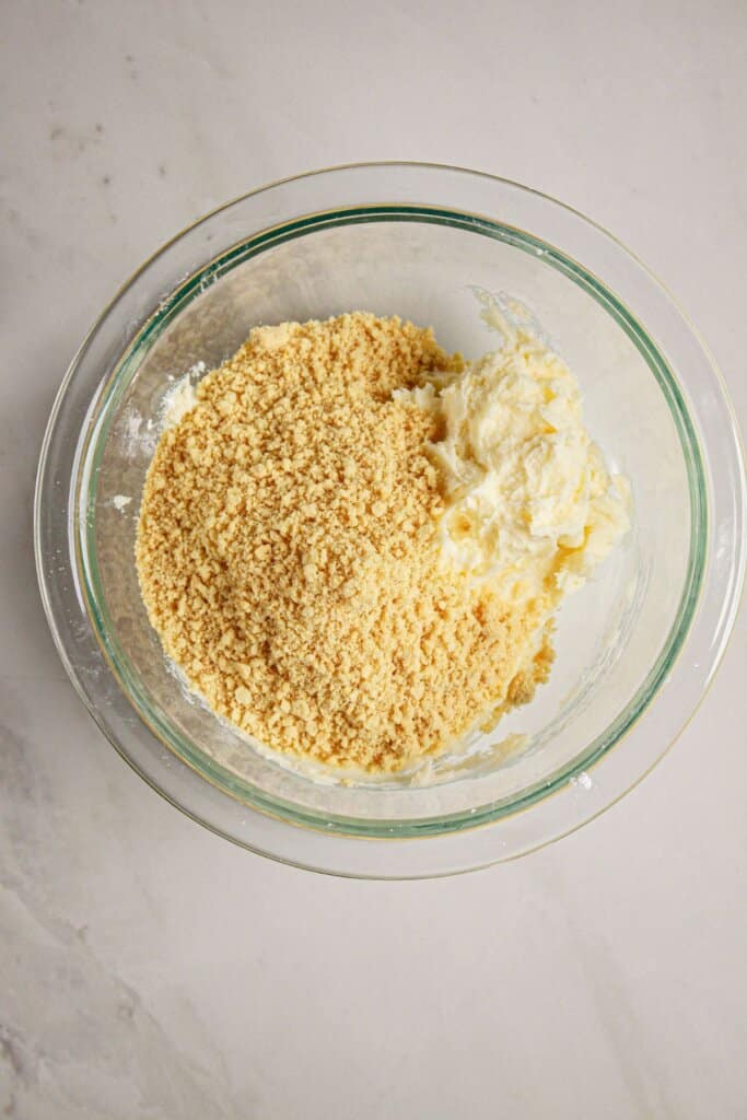 Cookie pieces being mixed into frosting.