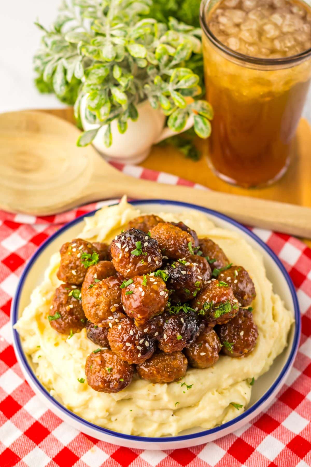 Mashed potatoes topped with honey garlic meatballs.