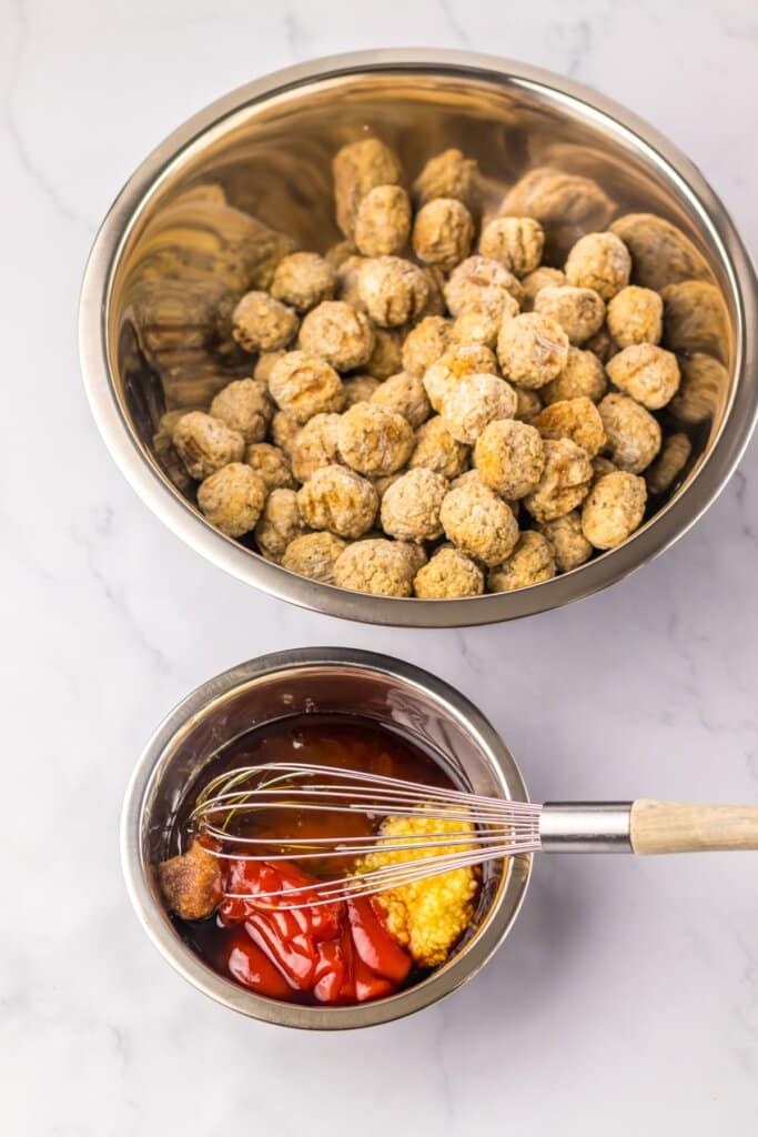 Sauce being mixed in a small metal bowl.