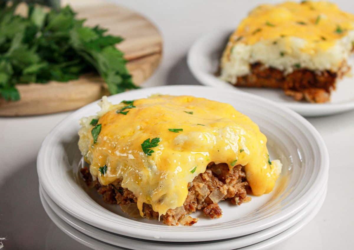 Slice of loaded potato meatloaf casserole on a plate.