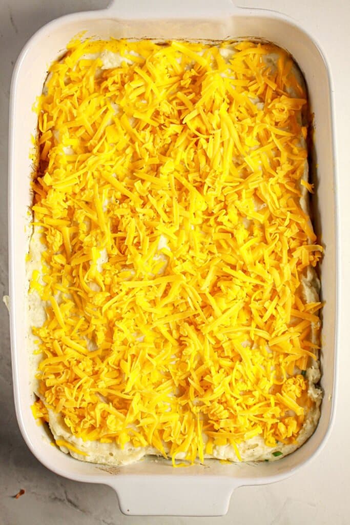 Shredded cheese sprinkled on top of a baking dish.