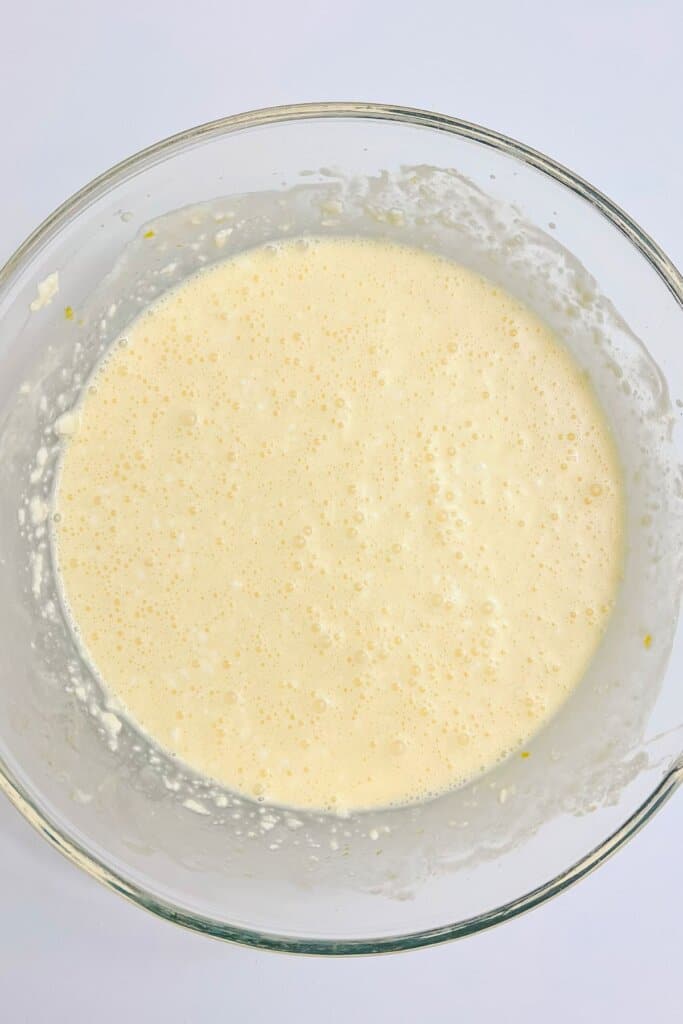 Batter being mixed in a glass mixing bowl.