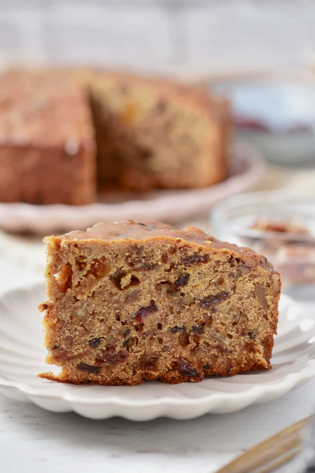 Slice of fruit cake on a plate.