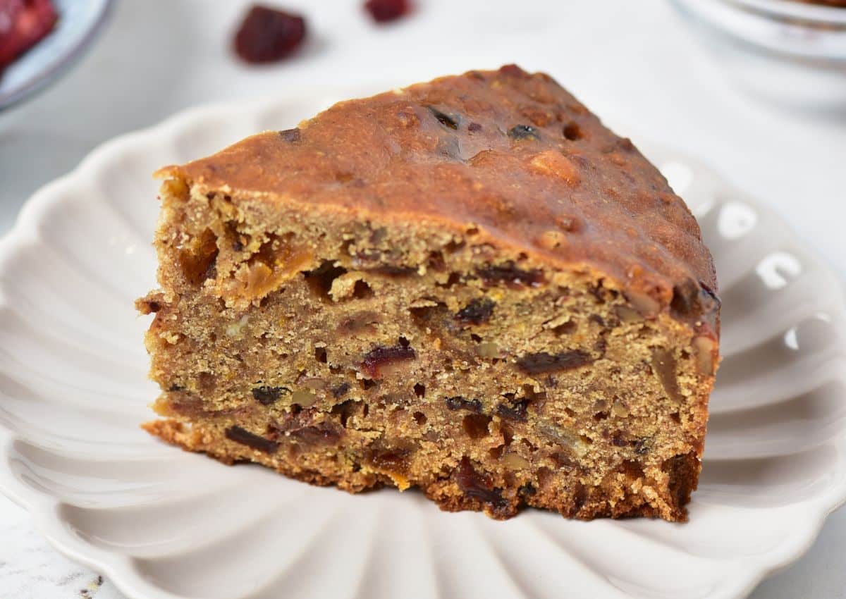 Slice of fruit cake on a plate.