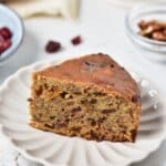 Slice of fruit cake on a plate.
