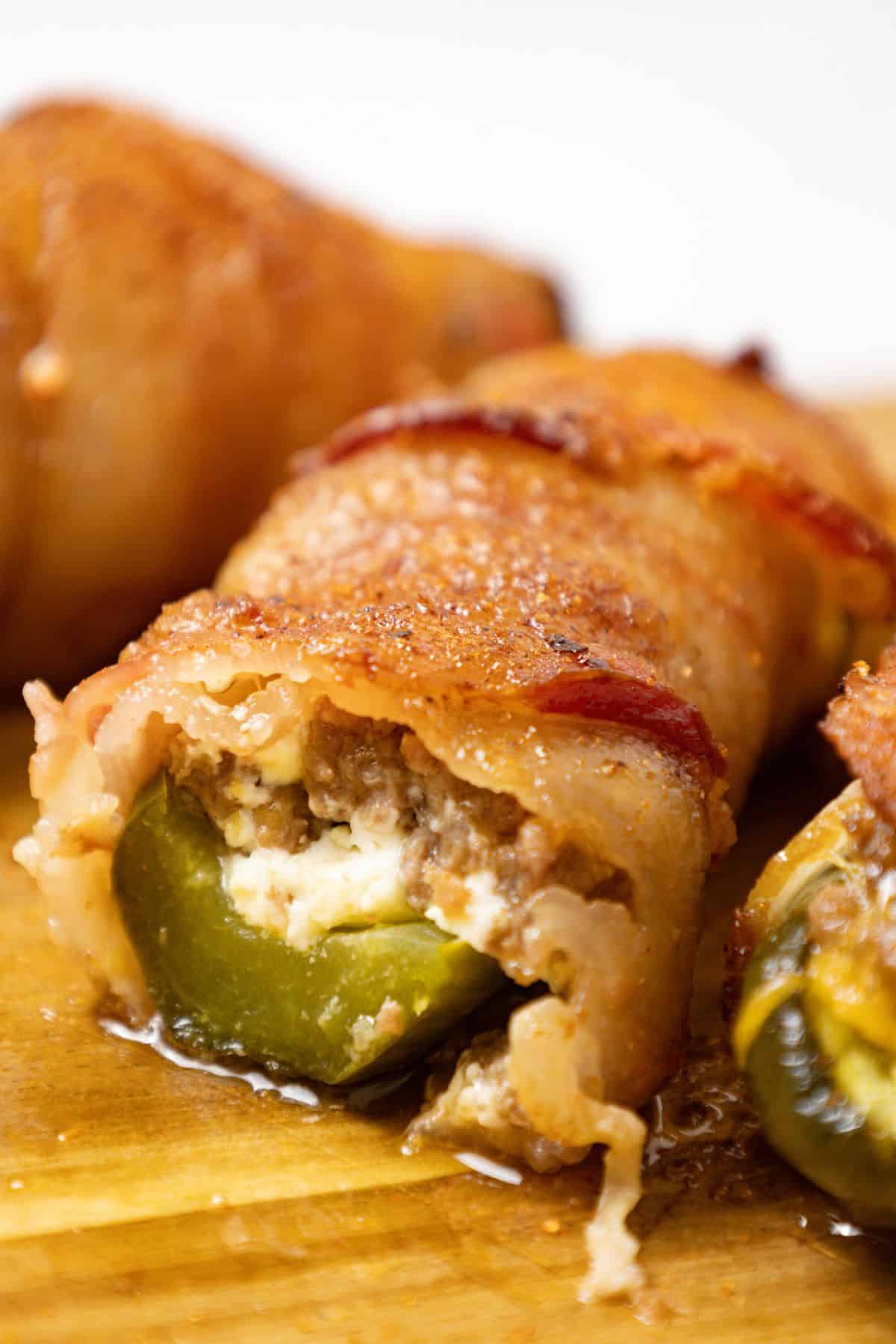 Pickle poppers stacked on a cutting board.