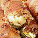 Pickle poppers stacked on a cutting board.