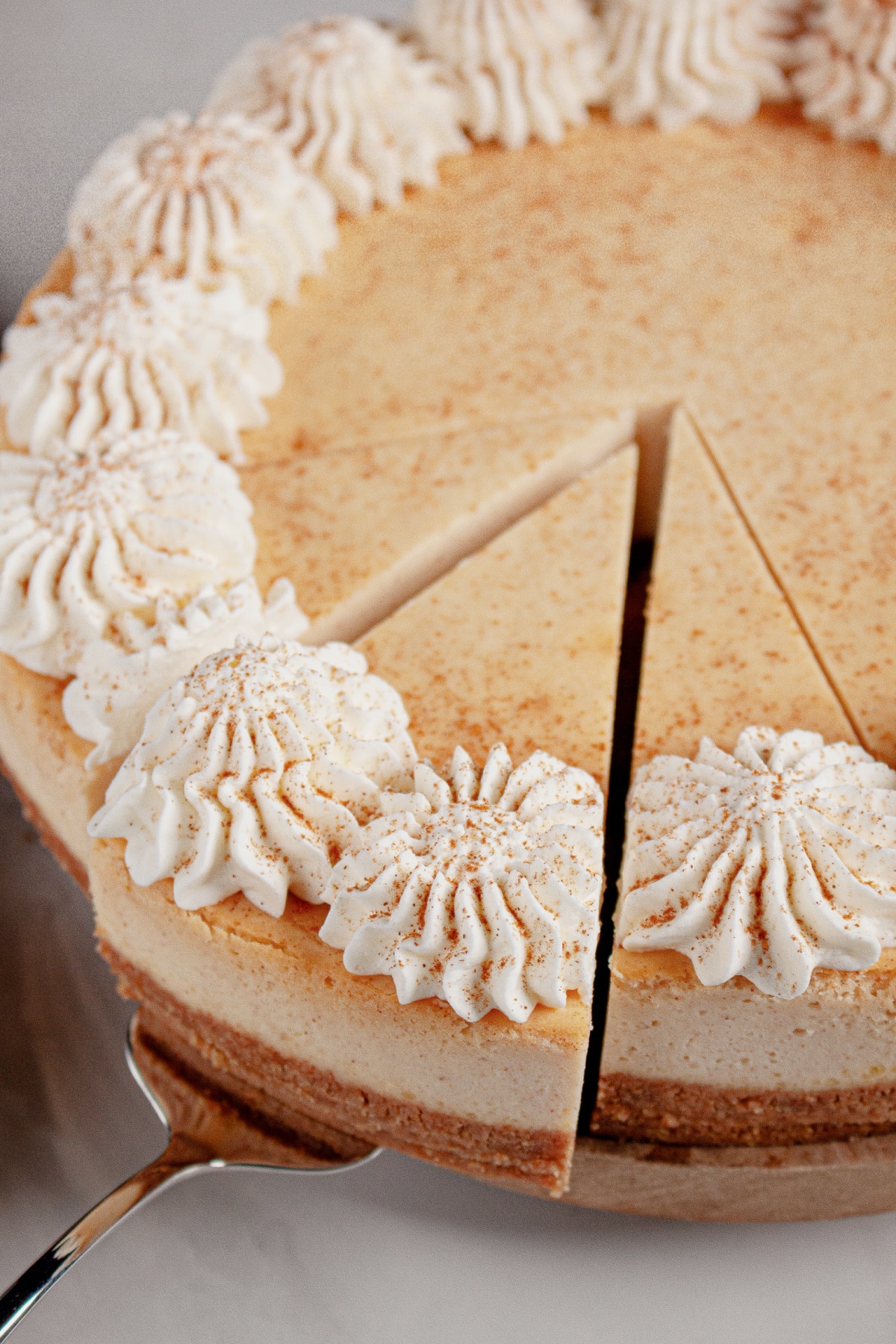 Slice of cheesecake being removed.