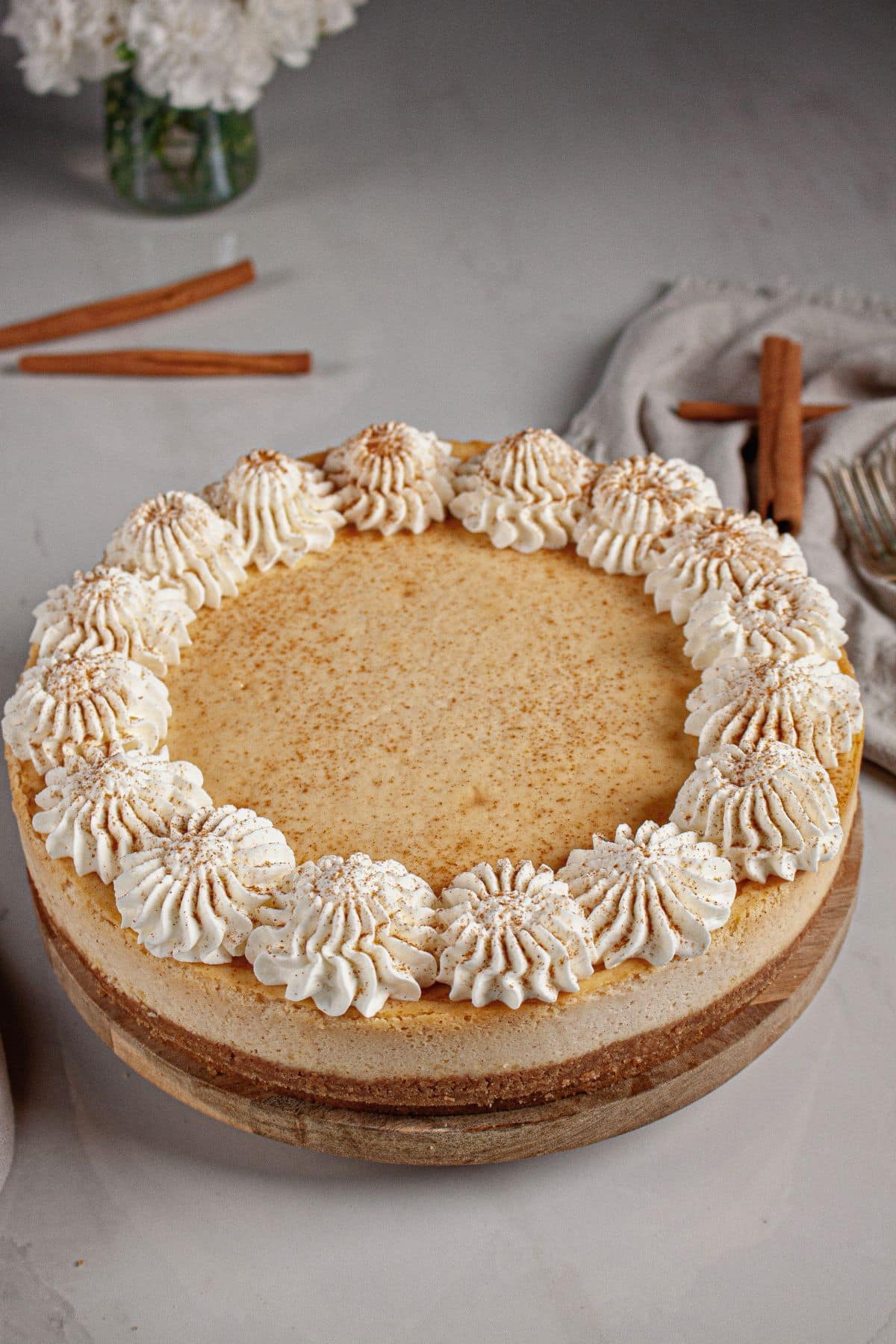 Cheesecake topped with whipped cream.