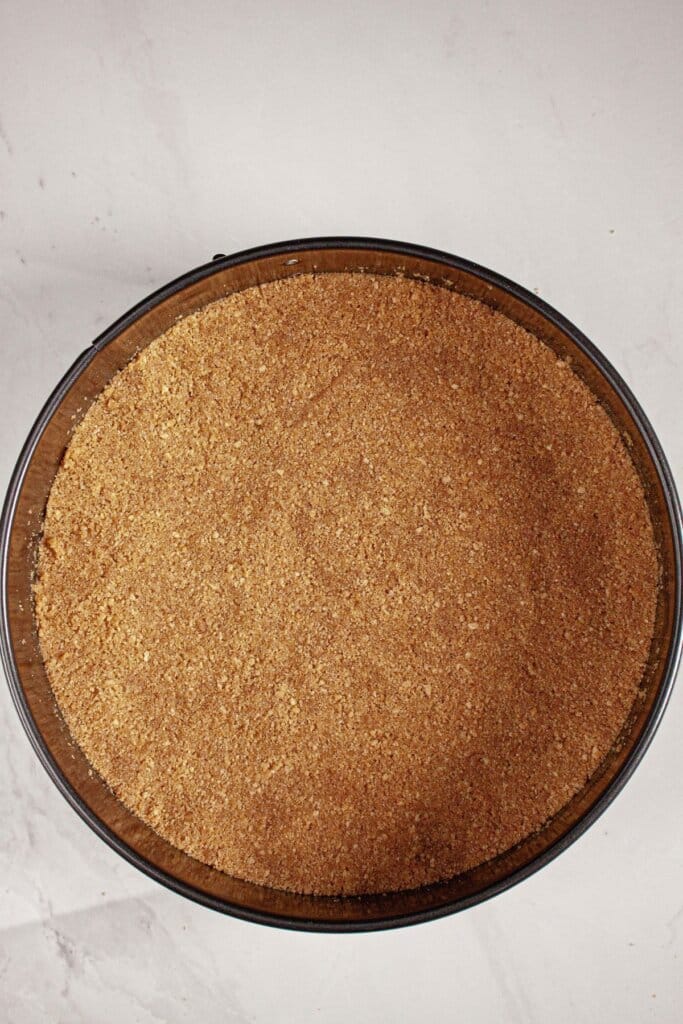 Graham cracker crust pressed into a springform pan.