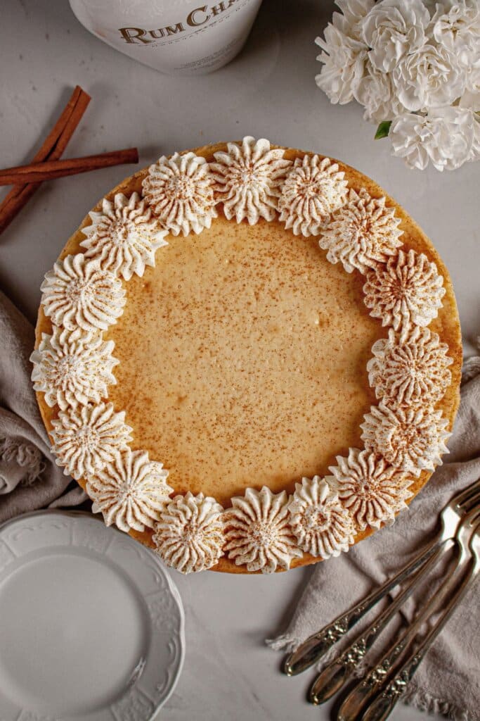 Cheesecake topped with whipped cream.