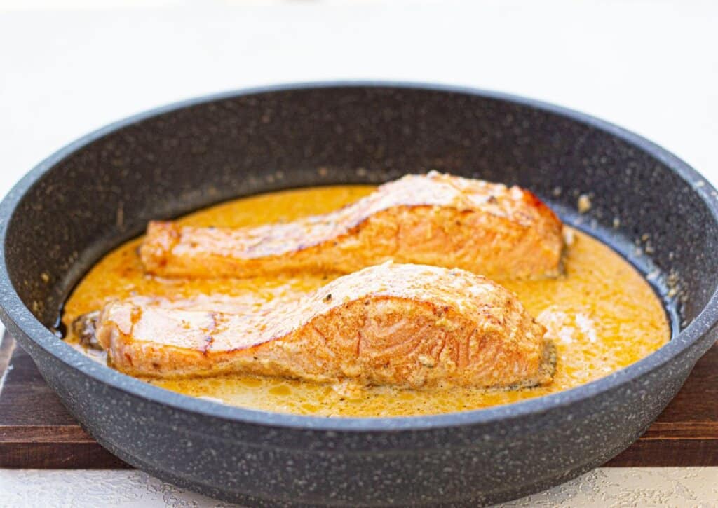 Fish being cooked in a skillet.