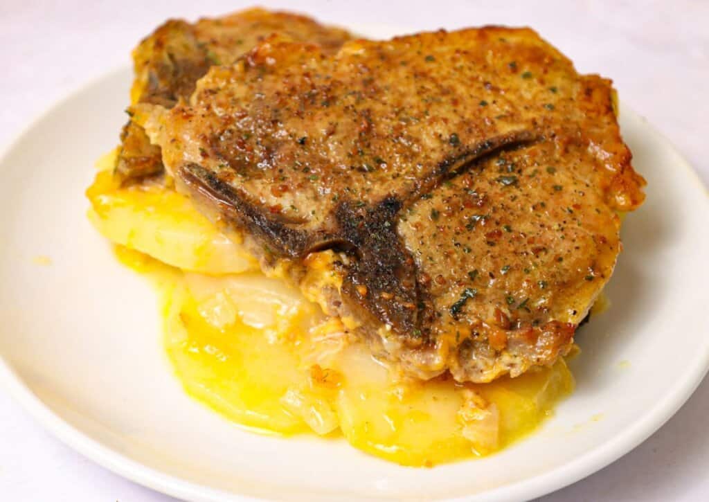 Pork chops and scallopped potatoes on a plate.