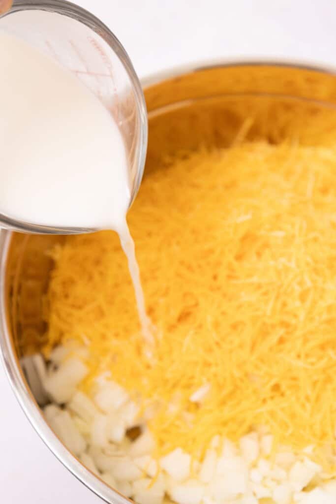 Milk being added to a mixing bowl.
