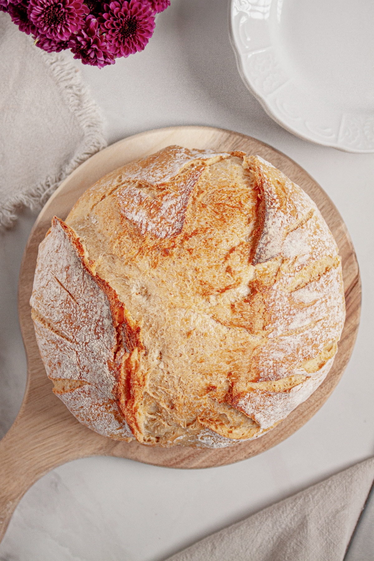 Loaf of dutch oven bread on cutting board.