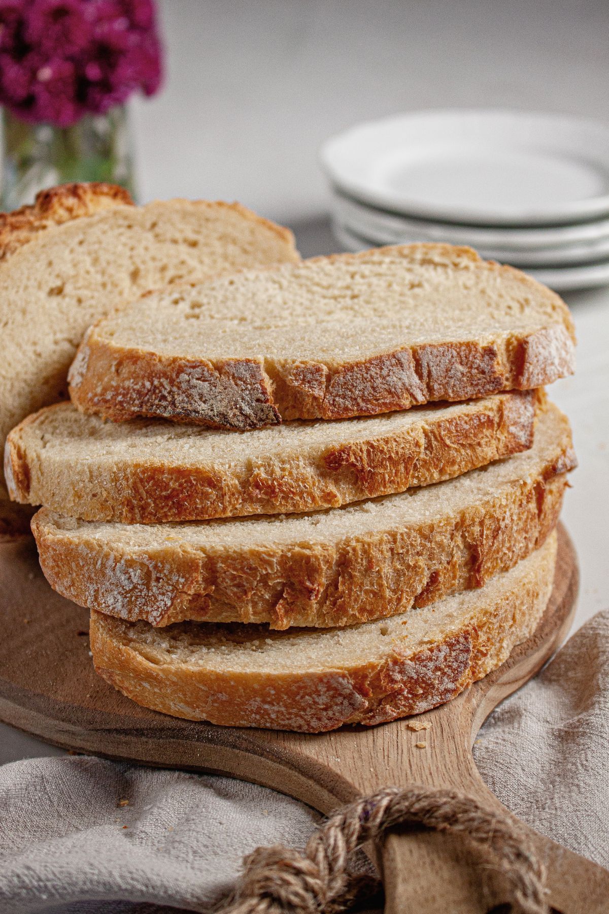 Slices of sourdough bread on a wooden cutting board.