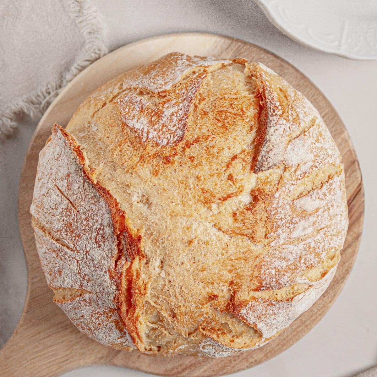 Loaf of dutch oven bread on cutting board.