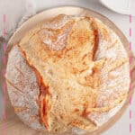 Loaf of dutch oven bread on cutting board.