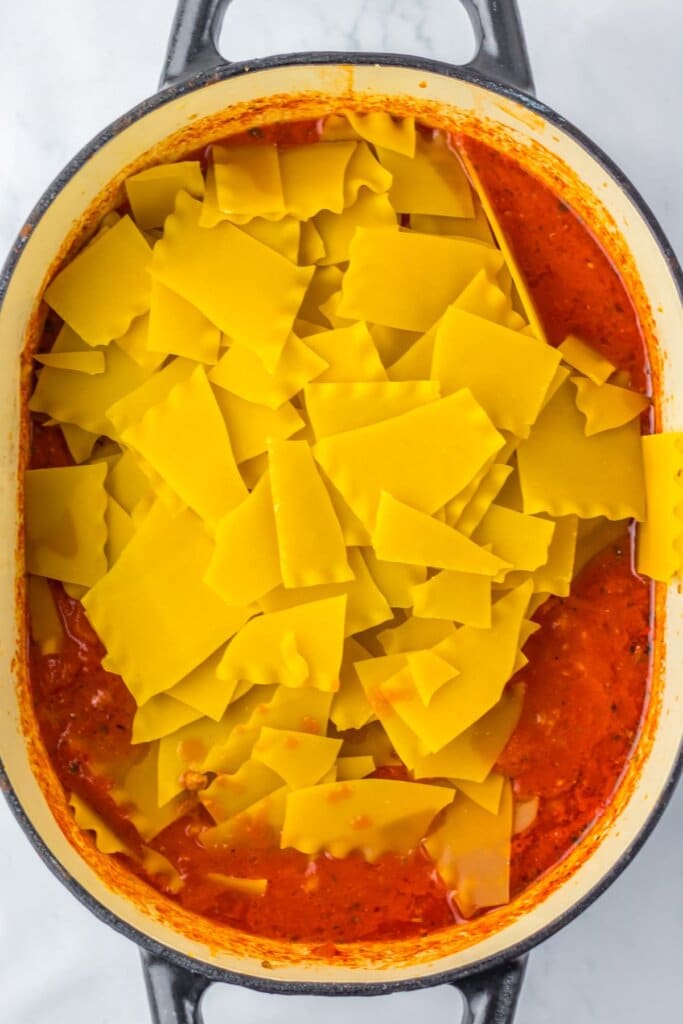 Noodles being added to pot.