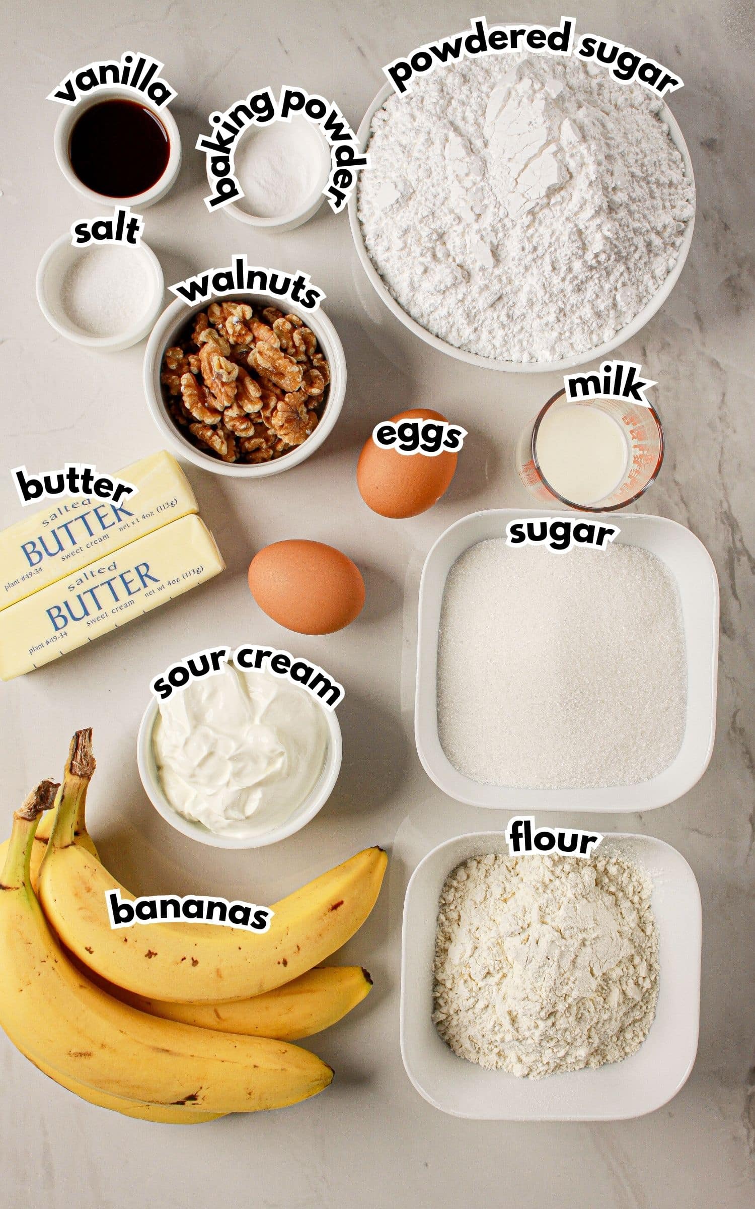 Bowls of ingredients labelled with text on a counter.
