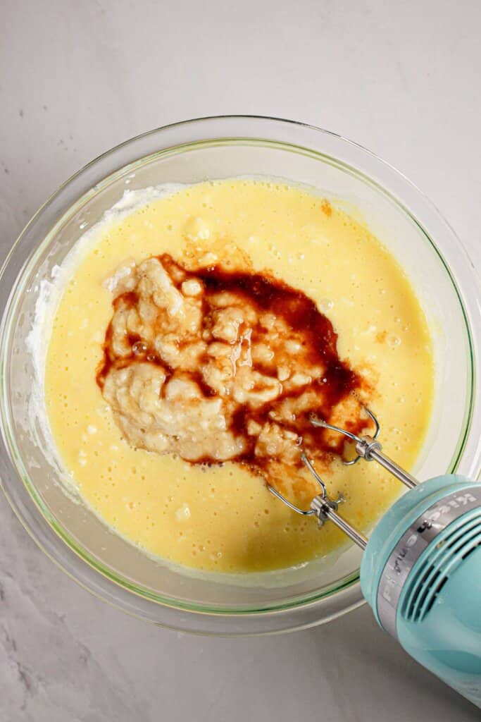 Banana and vanilla being mixed into batter.