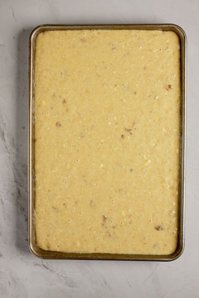 Banana bread batter in a jelly roll pan.