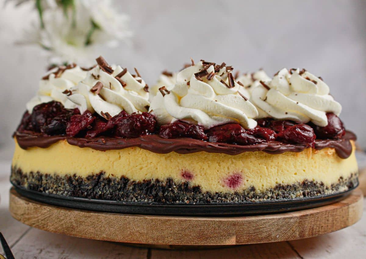 Black forest cheesecake on a wooden turntable.
