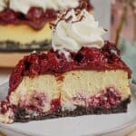 Slice of black forest cheesecake on a small plate.