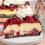 Slice of black forest cheesecake on a small plate.