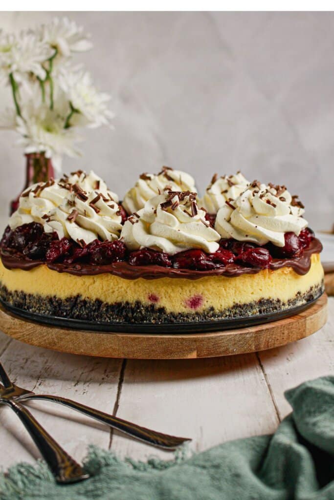 Black forest cheesecake on a wooden turntable.