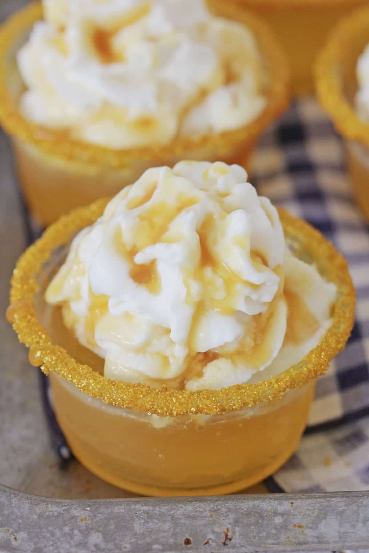 Butterbeer shots on a metal baking sheet.