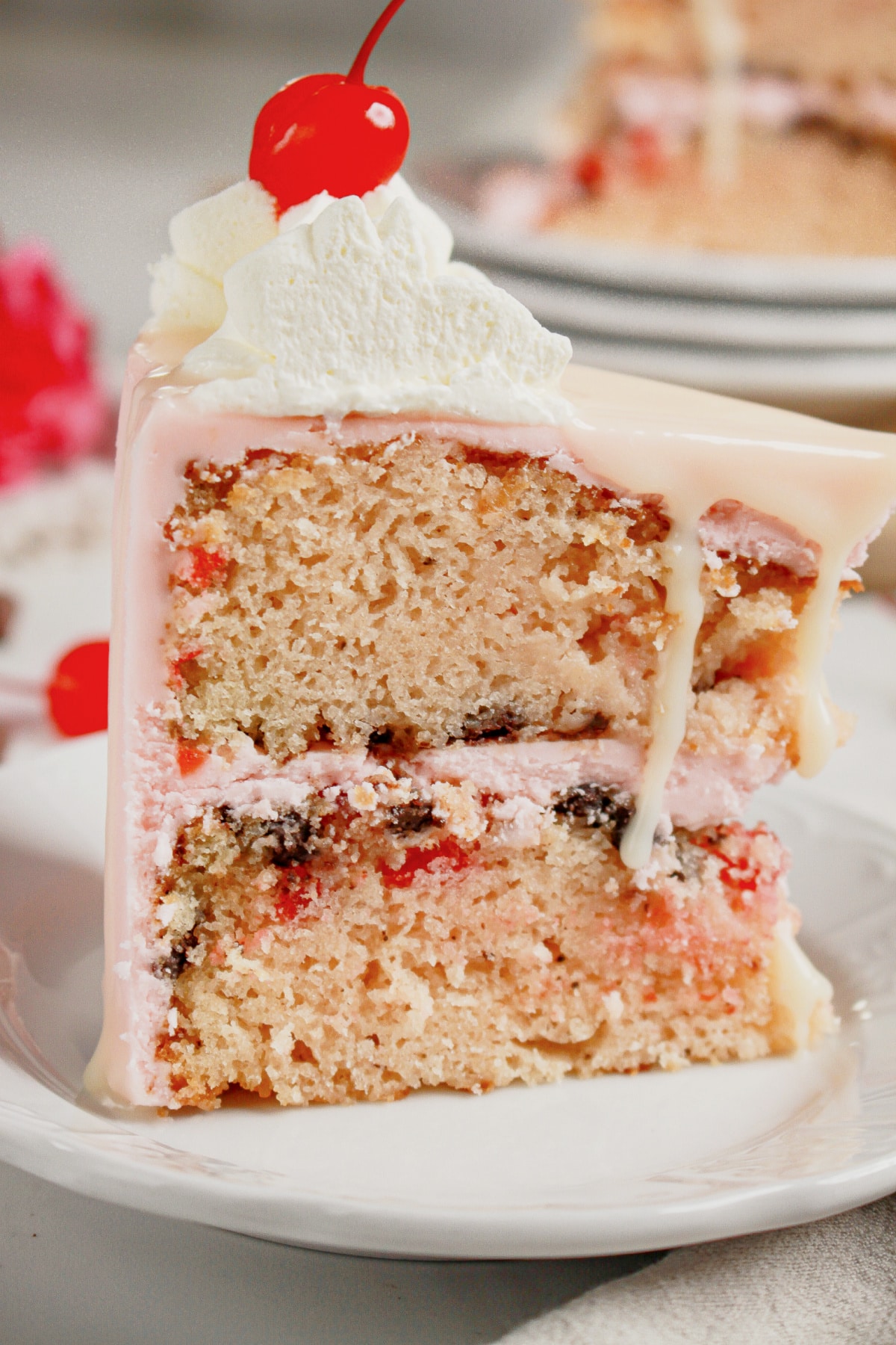 Slice of cherry chip cake on a small plate.