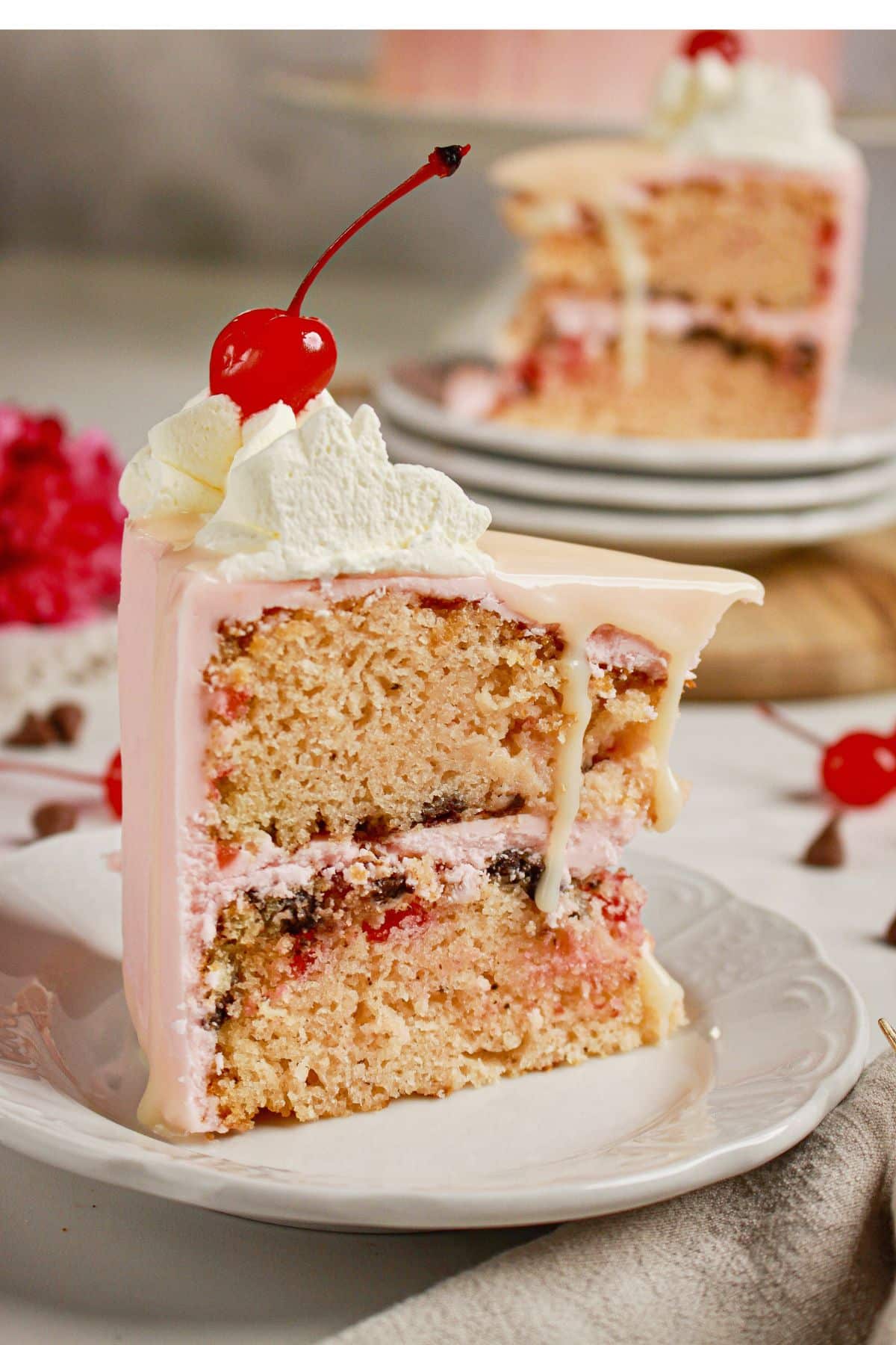 Slice of cherry chip cake on a plate.