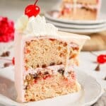Slice of cherry chip cake on a small plate.