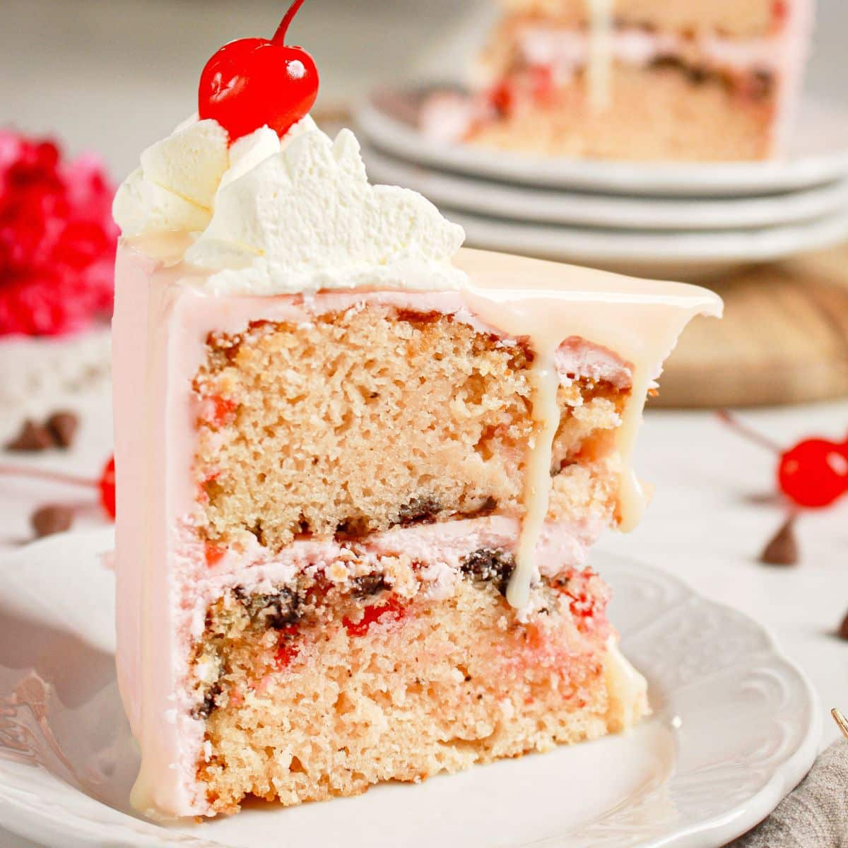 Slice of cherry chip cake on a small plate.