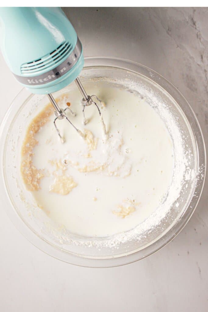 Batter being mixed in a glass mixing bowl.