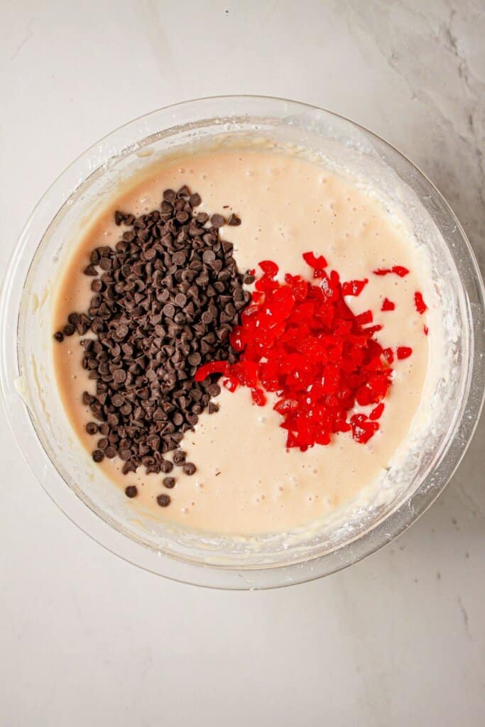 Chocolate chips and pieces of cherries in batter.