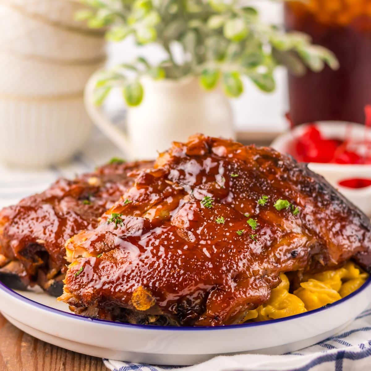 Ribs on a plate with mac and cheese.