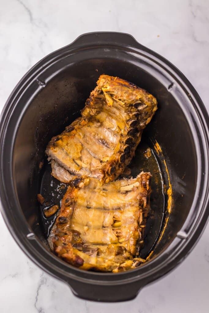 Cooked meat in a crock pot.