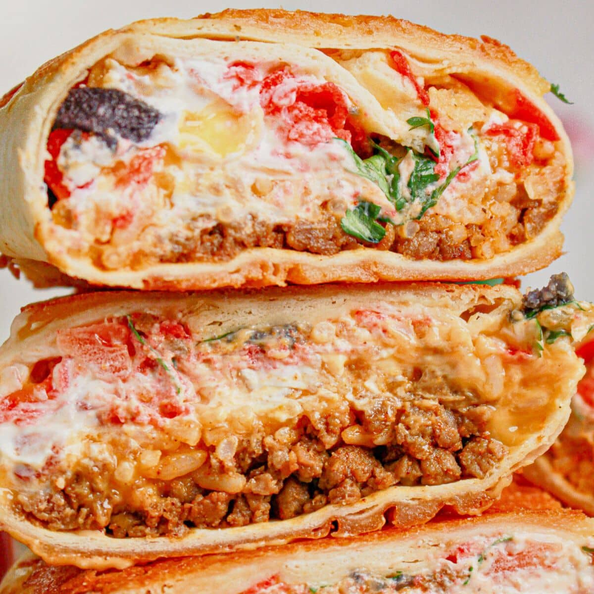 Grilled cheese burrito cut in half.