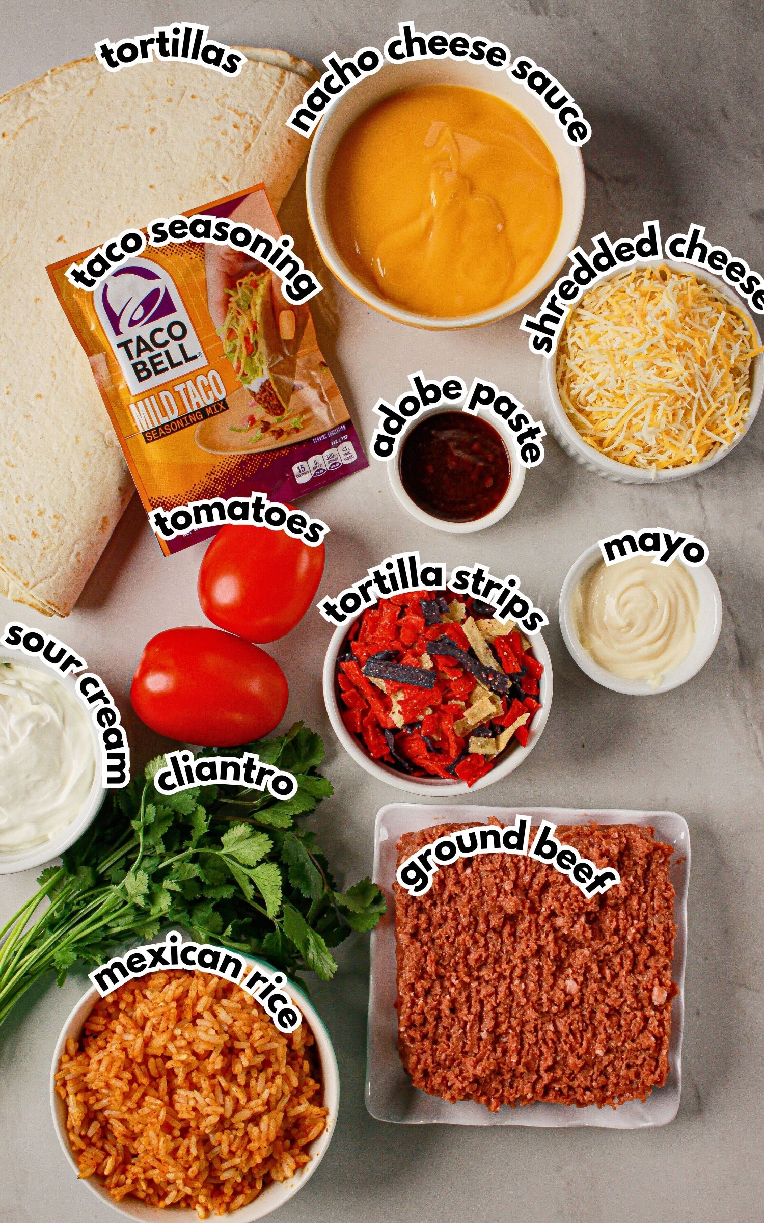 Bowls of ingredients labelled with text on a counter.