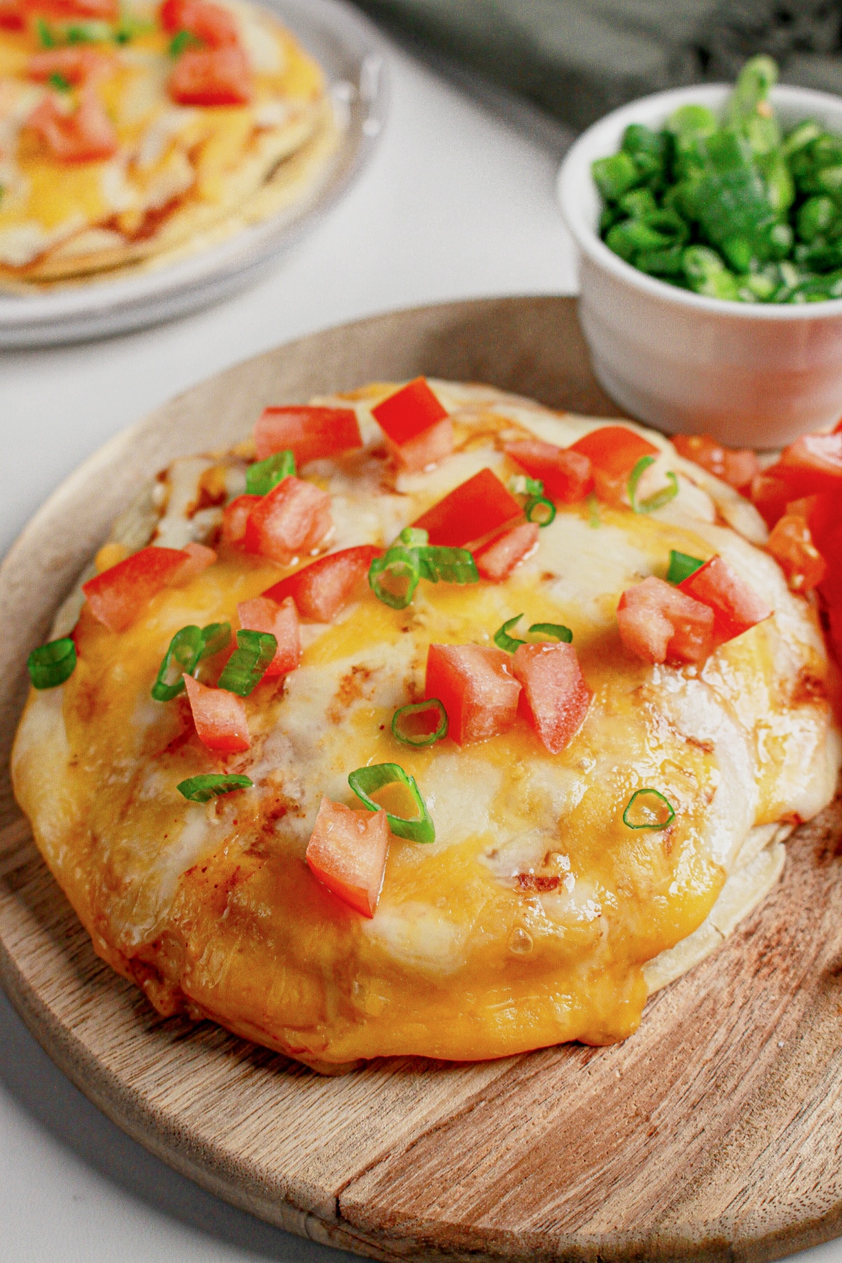 Mexican pizza on a wooden cutting board.