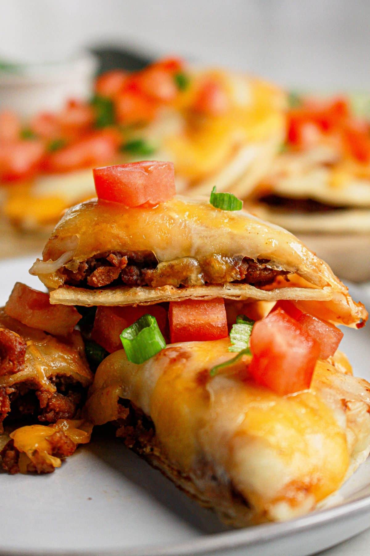 Slices of mexican pizza on a white plate.