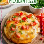 Mexican pizza on a wooden cutting board.