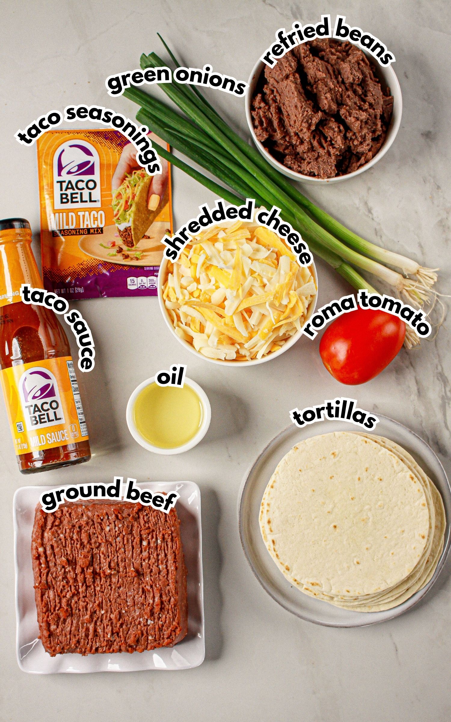 Bowls of ingredients labelled with text on a counter.