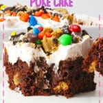 Slice of monster cookie poke cake on a white plate.